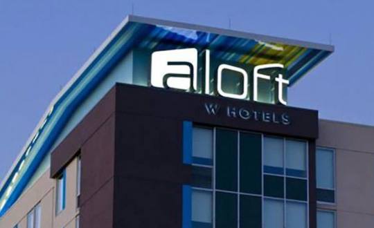 Aloft LED sign on top of building by national signs, a sign company in houston, texas.