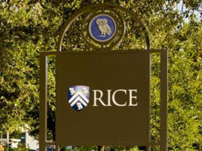 Rice University in Houston post and panel sign indicating a parking lot entrance on campus