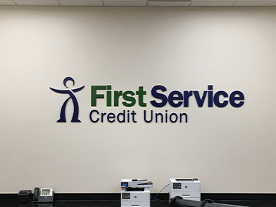 An indoor bank sign we designed and installed for First Service Credit Union in Houston, Texas