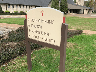 One of many post and panel signs across a Houston church ground.