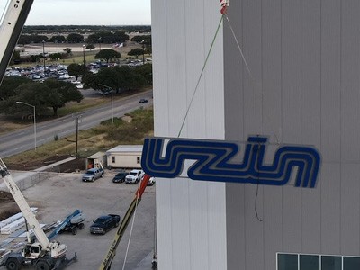 The National Signs installation team installing a new sign for Uzin.