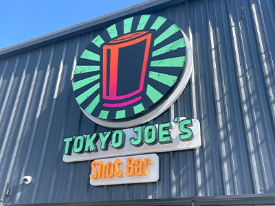 Outdoor restaurant sign for Tokyo Joe’s in Texas.
