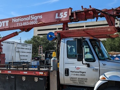 Sign installation and repair truck with National Signs decals.